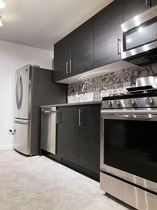 Brand new kitchen with all new high efficiency Samsung stainless steel appliances, including: gas stove, french door fridge with pullout freezer, microwave, dishwasher, delta faucet, concrete styled countertops and flooring