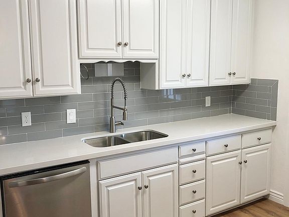 Kitchen with Brand New countertops, backsplash sink and dishwasher