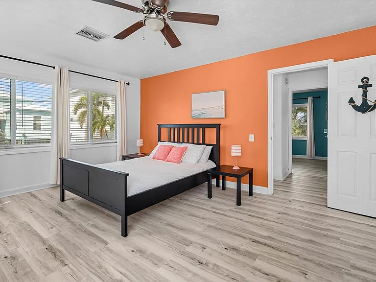 Master bedroom with plenty of space and lots of bright light shining in.