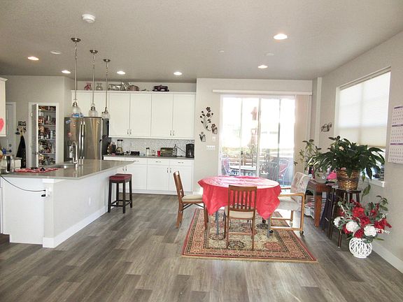 Dining area with kitchen to left, upgraded vinyl plank flooring for easy maintenance