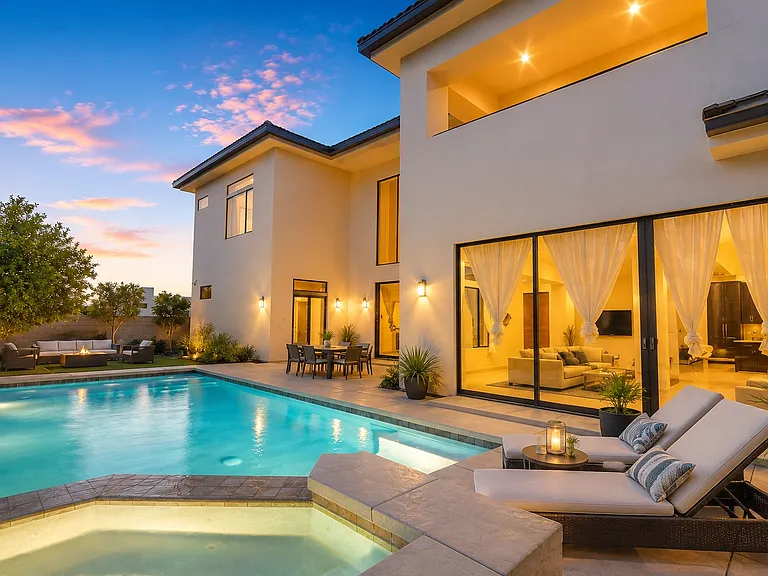 Resort-style backyard with a sparkling pool, spa, outdoor lounge, dining patio, and seamless indoor-outdoor living.