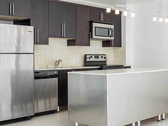 Kitchen with Island and Stainless Steel Appliances