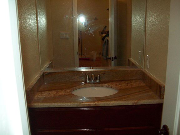 Bathroom with granite counter top.