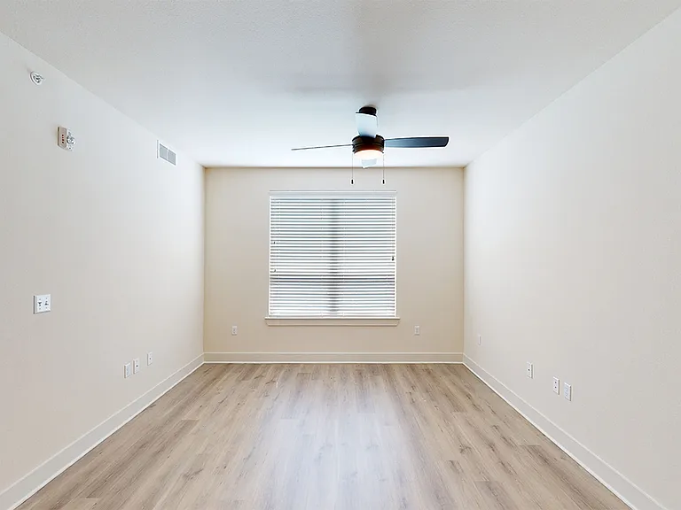 Apartment dining and living room with wood-style flooring.