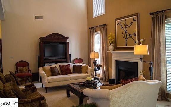 This den area is an open floor plan just off the kitchen. Carpeted. Great layout for entertaining!