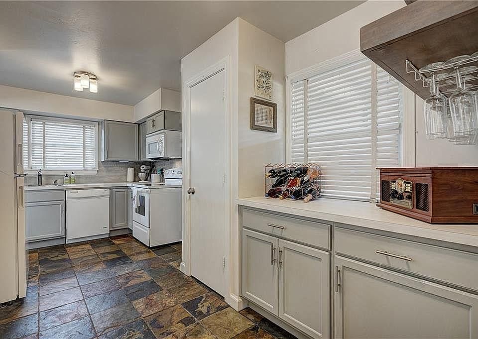 Great kitchen layout with a large pantry! Wonderful roomy wine/coffee serving bar and wine glass rack and floating shelves! Tons of storage!