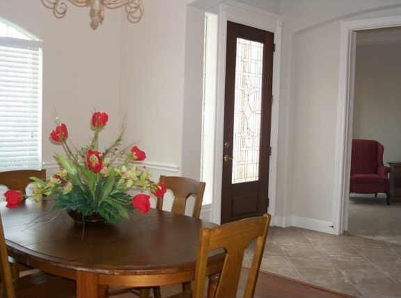 formal dining room with new wood laminate floor. Beautiful beveled glass front