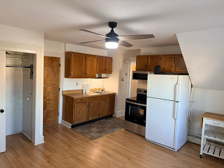 Kitchen from a different angle. shows closet, entry door, and sink