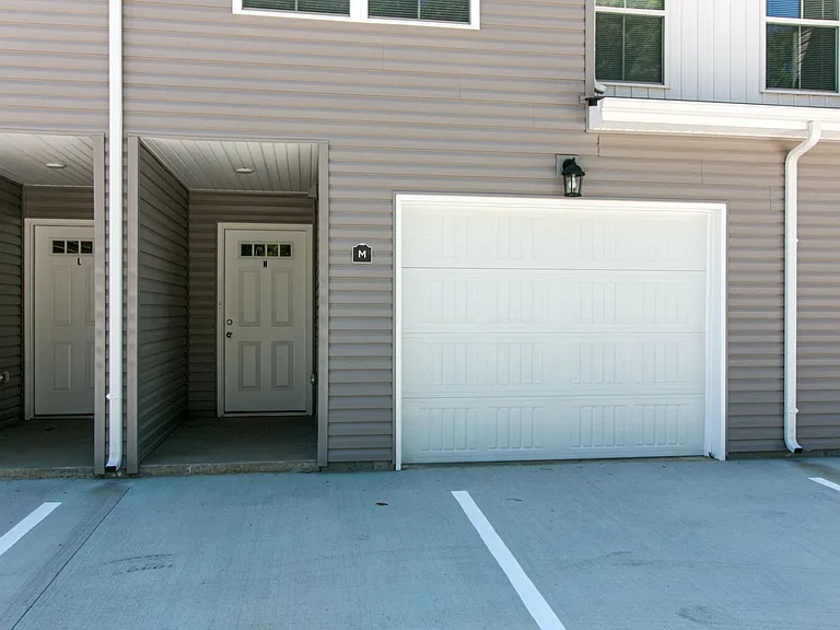 Front of Condo with 2 parking spaces in front of unit. Remote Control for Garage Door