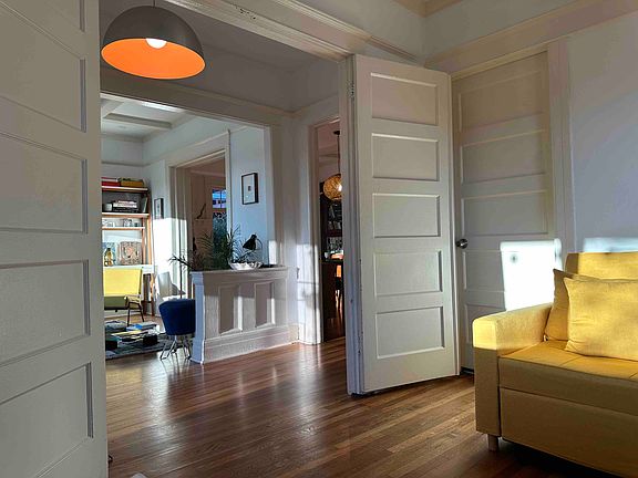 Room shown here with possible configuration for a bed, desk, armchair, and storage. Room is currently unfurnished.