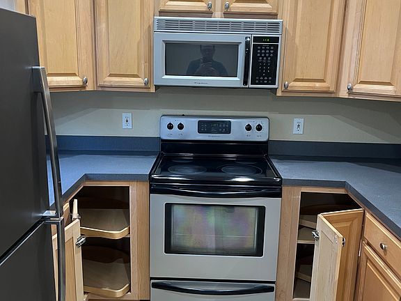 Kitchen with cabinet doors open.