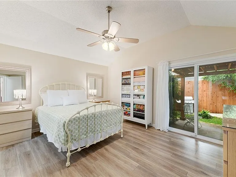 Primary bedroom with access to the backyard and a private covered patio.