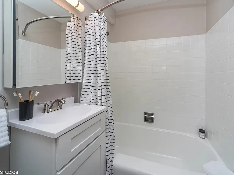 Full size tub in the modern bathroom at Archer Tower in Denver, CO