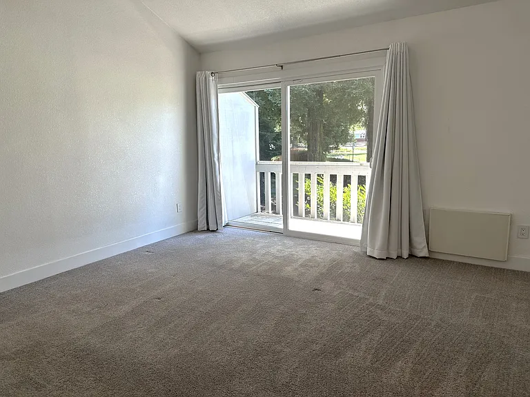 Rear bedroom with deck. Room measures 13'8" x 13'8".