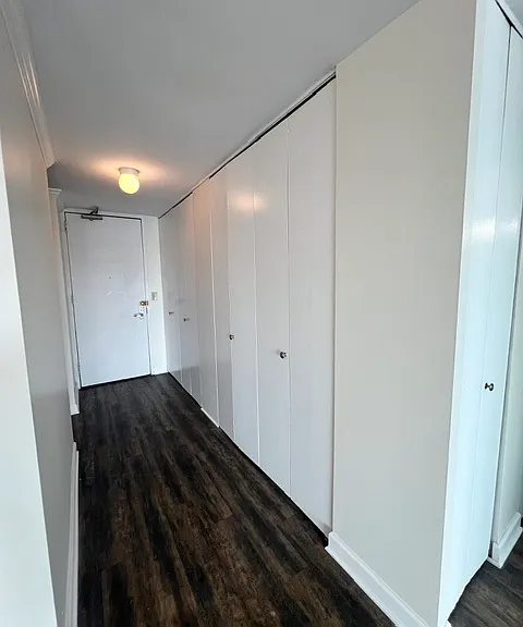 Hallway with a wall of closets