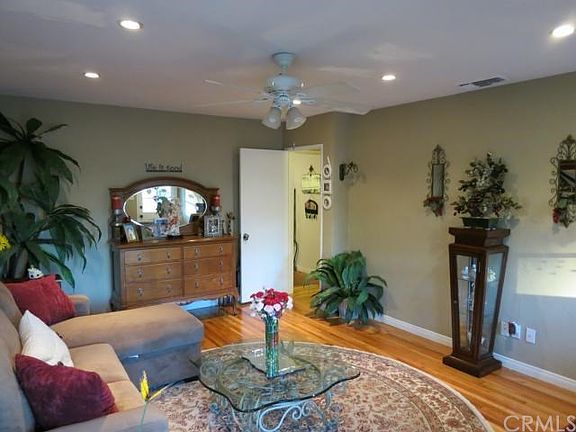 Living room with ceiling fan, designer colors and hardwood f