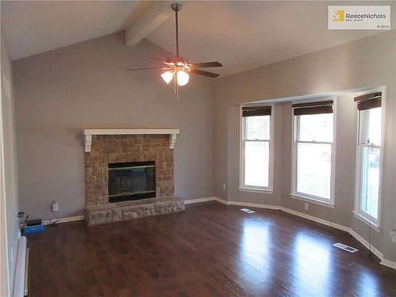 The living room features lovely, vaulted ceilings, wood-burning fireplace, and lots of natural light. A welcoming first impression as you begin your tour.