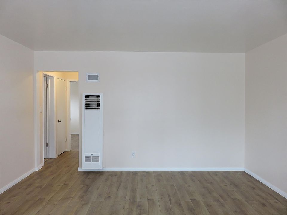 Living room area, leading to hallway, bedrooms, bathroom area