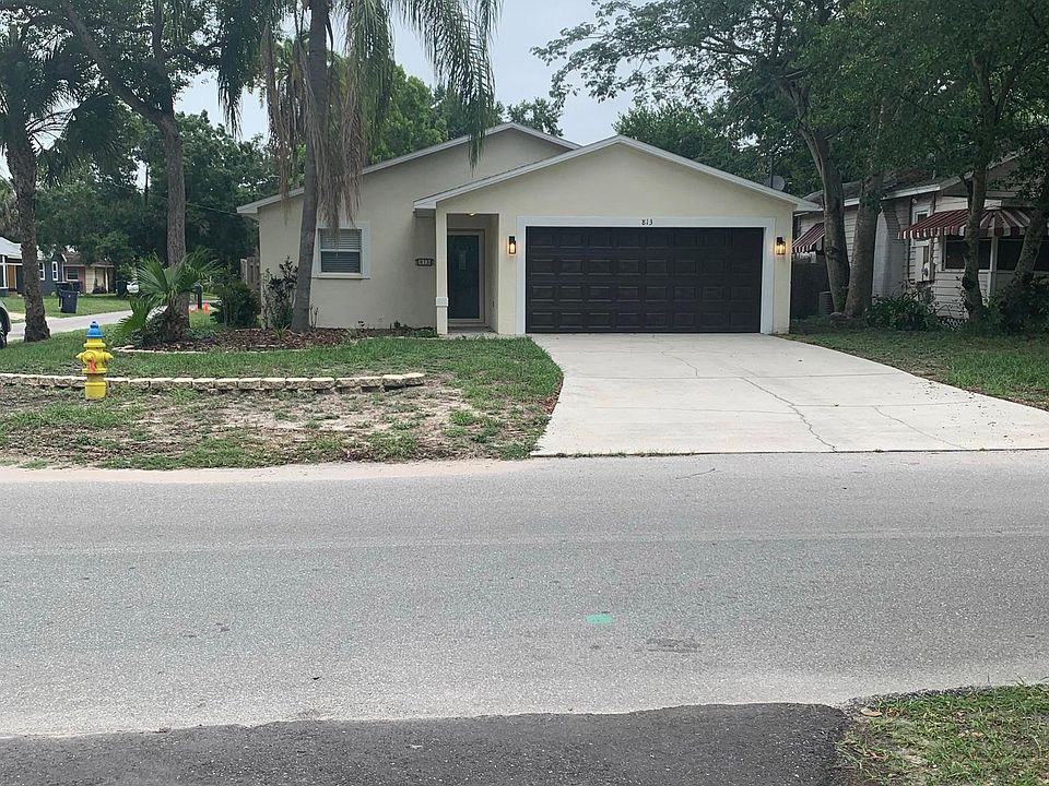 Front of house. Faux wood painted garage door and front door