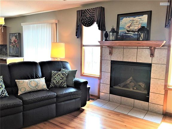Family room and fireplace with gas logs.