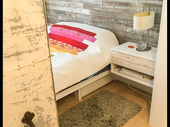 Bedroom with Custom metal sliding door & Antique barn track