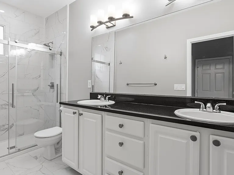 Master bathroom with double vanity and walk-in shower