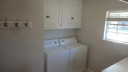 Laundry room w/ washer & dryer & storage