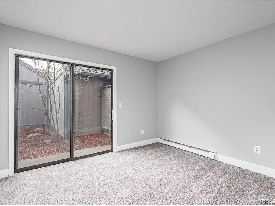 Second bedroom with private access to patio. Carpet has been replaced with wood vinyle floorings