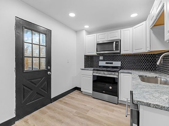 Kitchen (Stove, Microwave and Dishwasher). Exit door to Patio.