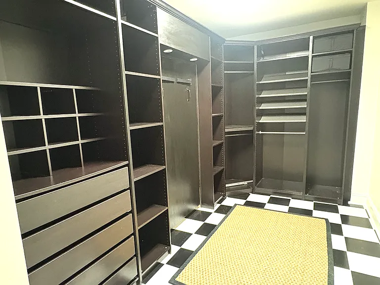 Huge walk-in closet off of the bathroom. Large panel with accent lights conceals...