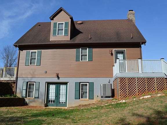 Back of house view. Shows basement entrance, main floor, third floor and both decks.