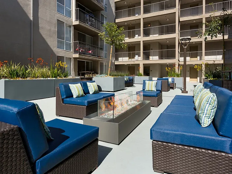 Resident courtyard with barbecue grills, fire pits, and lounge seating