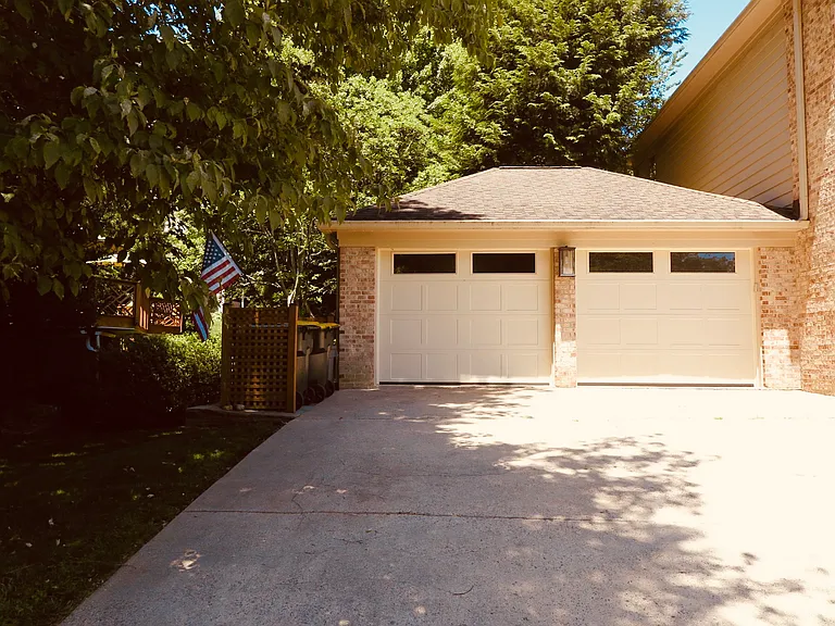 Garage fits two standard cars. Garage has back door, room for tools, and equipment. Extra refrigerator with top load freezer