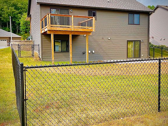 Exterior Back (featuring newly installed patio and fence)