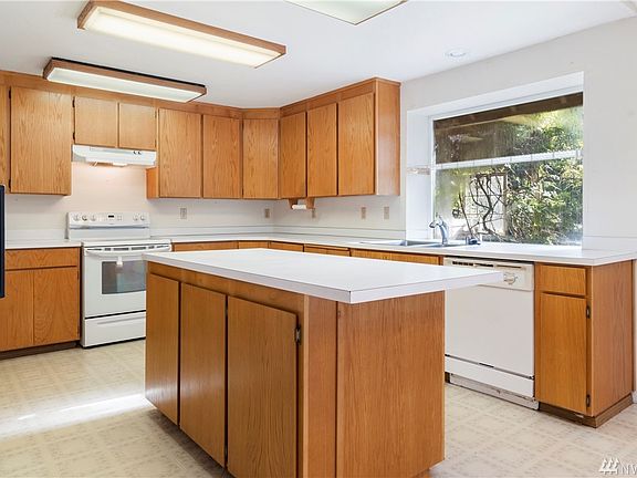 Kitchen with large center island.  Garden window over the sink. Refrigerator stays. 