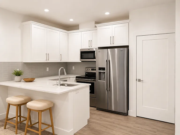 Kitchen with quartz counter-top, new stainless-steel appliances. Island supports comfortable sit-out