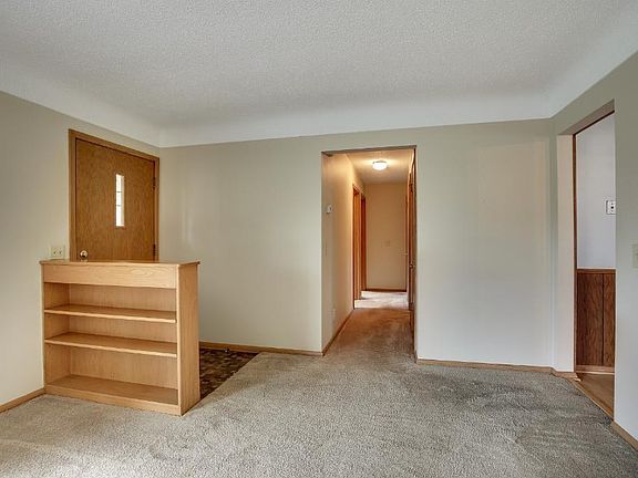 Front entry door has a greeting area defined by a built in book case.