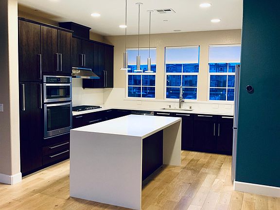 Modern and spacious kitchen with waterfall-style island and latest appliances to enjoy cooking your meals