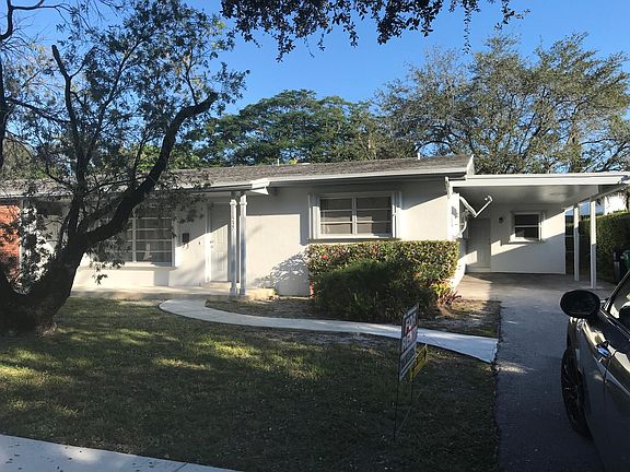 Front of home and covered carport.