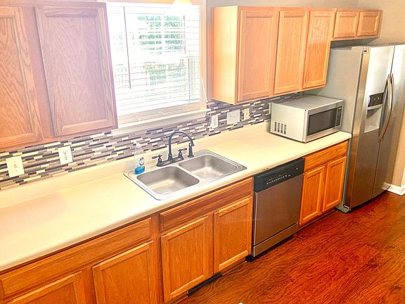 Large Kitchen with bar top, new tile backsplash, all wood floors, Appliances all replaced with stainless steel