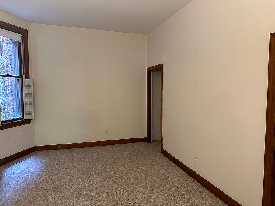 Looking into Bedroom which has 2 windows. One has the air conditioner 
Doors lead to kitchen and the bath. A large storage closet is also not shown