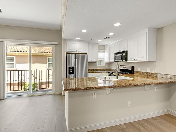Inside, is a light, bright, open living area, dining area, breakfast bar and beautiful kitchen.