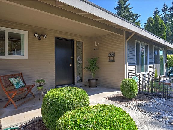 Inviting covered front porch with access to the primary bedrooms private patio
