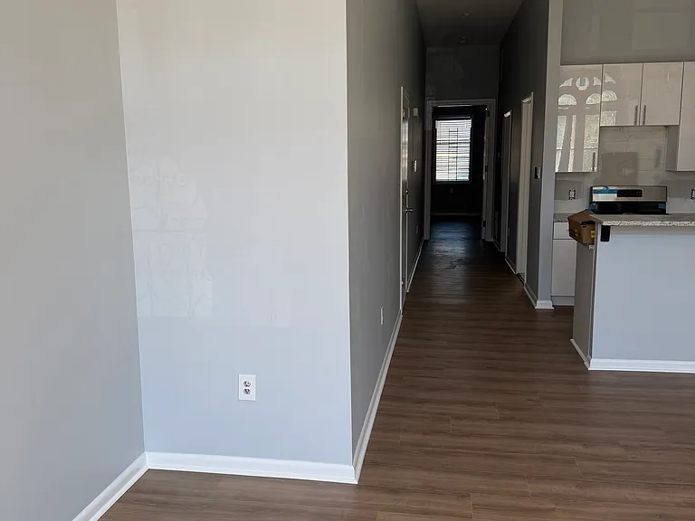 Living room space and long hallway.