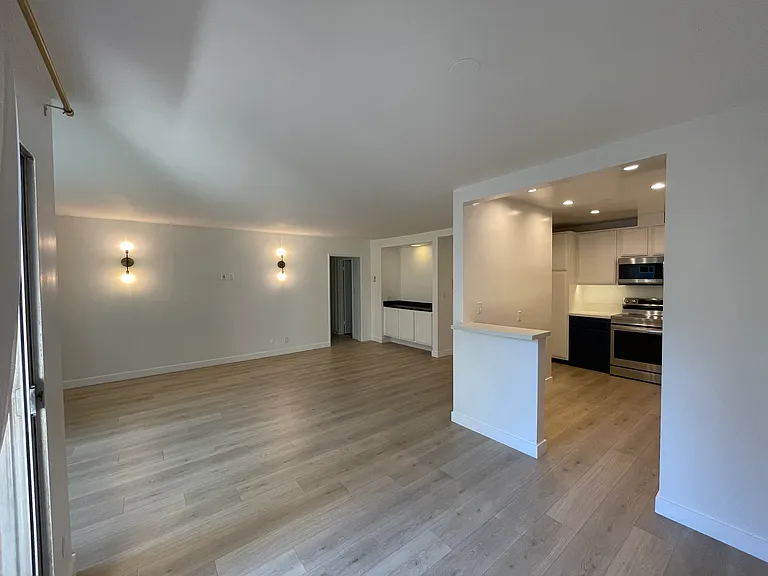 large living room. Open floor plan with counter from kitchen off of dining area and living room