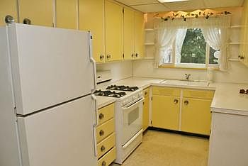 Cute kitchen has new appliances that are included.