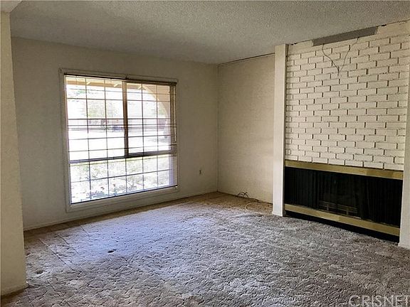 Living room, front window and gas fireplace.