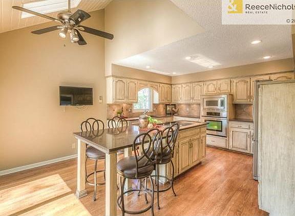 Spacious kitchen with vaulted ceilings and skylights, fauxed cab