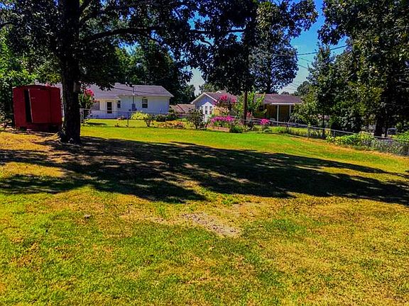Large fenced back yard with shed