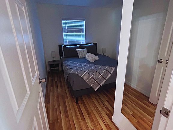 Inviting room with window, lamps, nightstands, and premium linens.